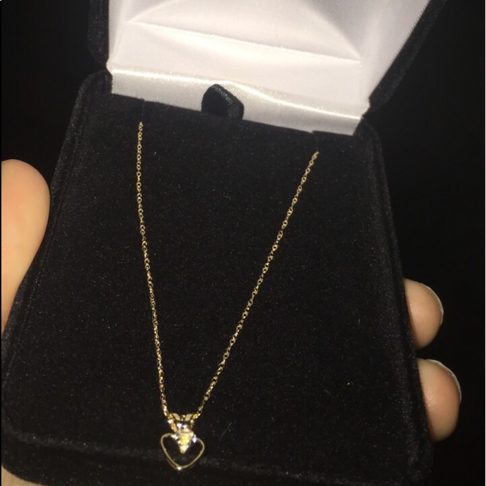 14kt gold Heart necklace with a diamond in it.